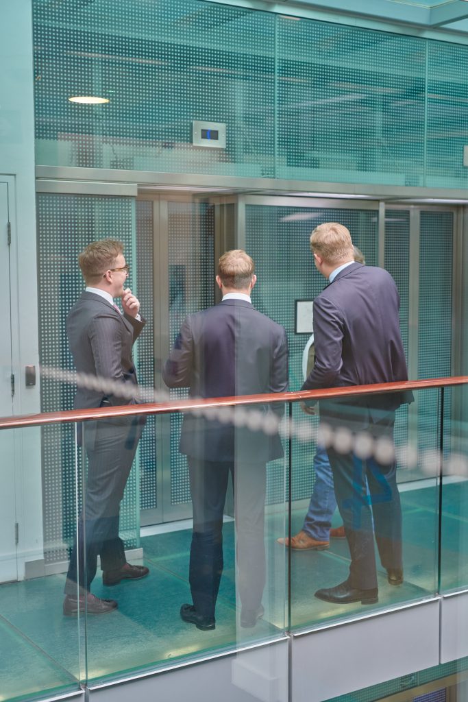 Albatross lending group waiting for lift in office